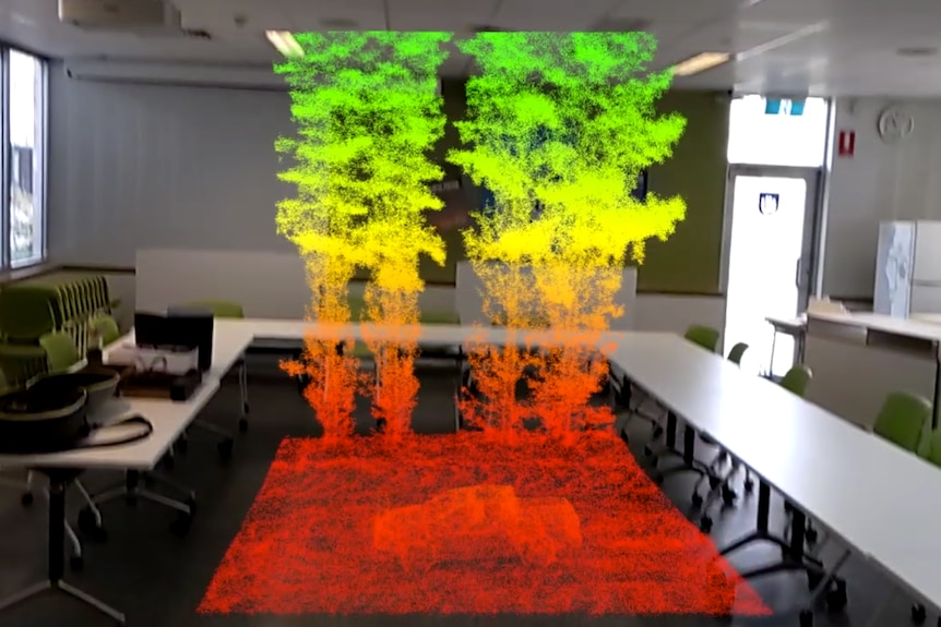 A hologram like image of a small plot of a forest floats in the middle of the room.