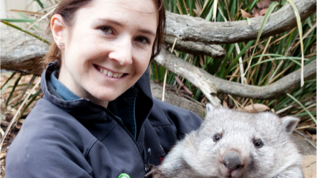 Zoo keeper Monique Spaulding cuddles a wombat.