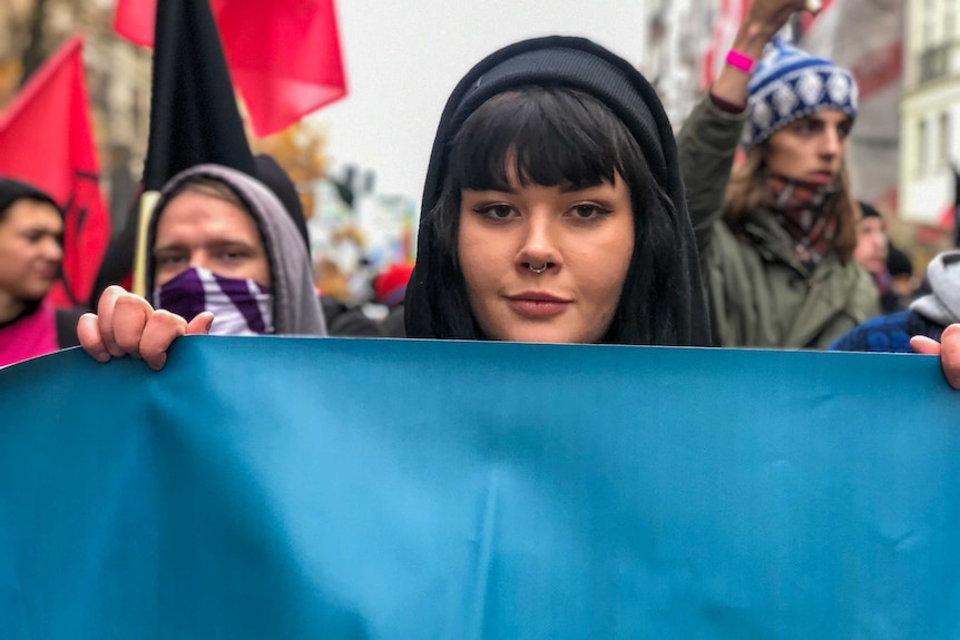 A woman holding a sign during a protest