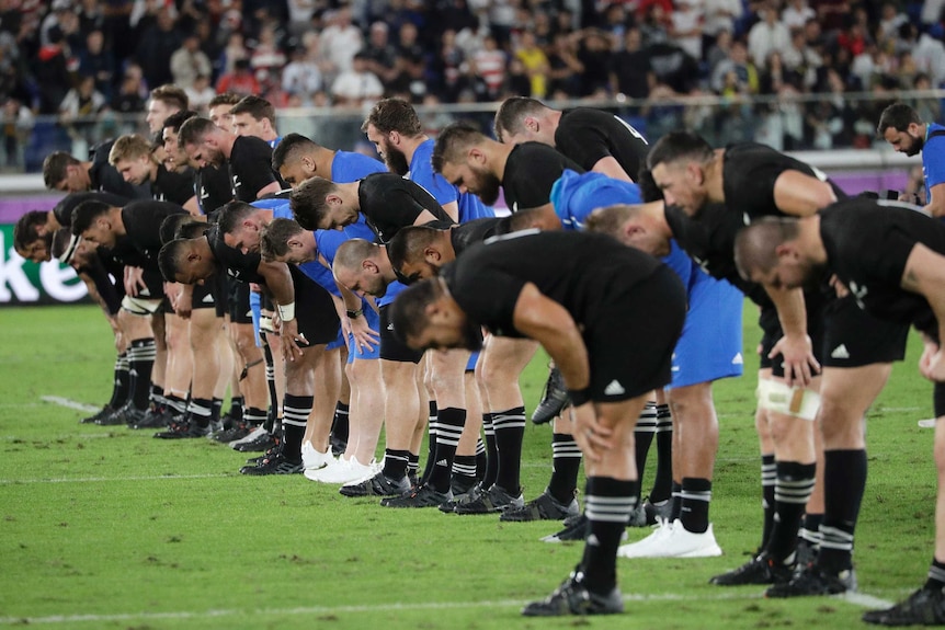 The New Zealand team bow to the crowd after their loss in their Rugby World Cup semi-final against England.