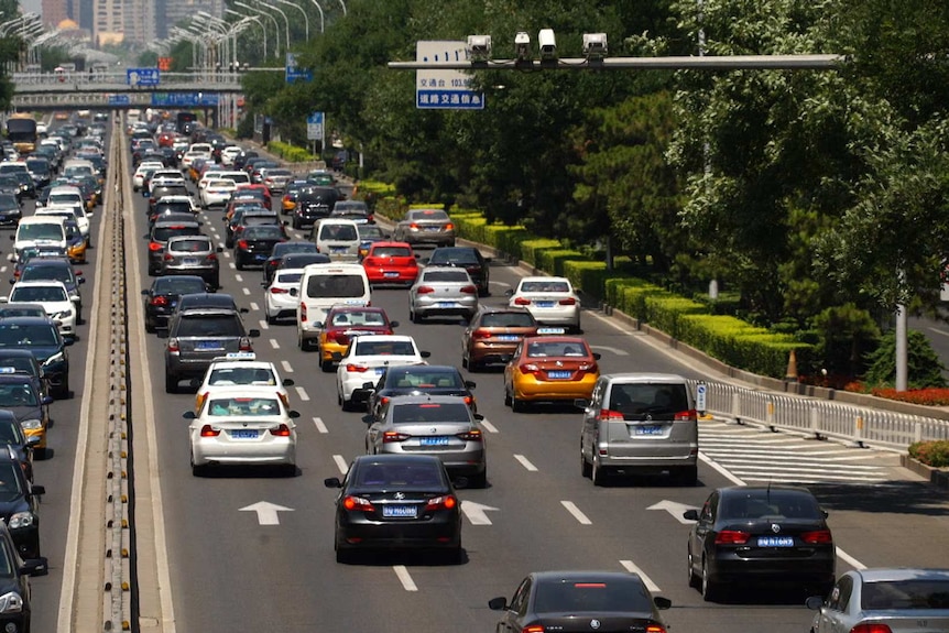 Overhead cameras film cars on a busy Beijing street.