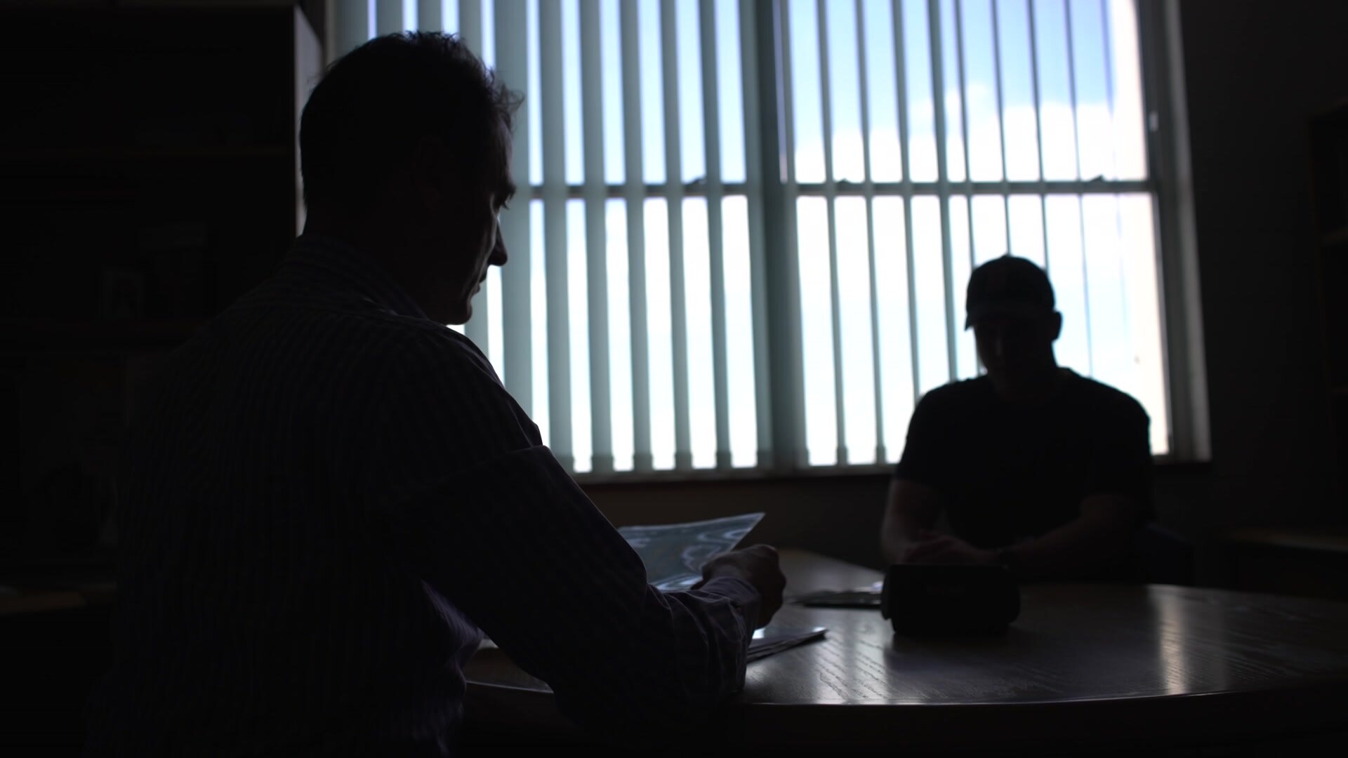 Two silhouetted figures in a room.