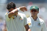 Mitchell Starc wipes the acrid sweat from his brow as his friend Peter Siddle looks on with concern