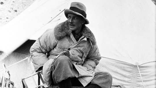 A black-and-white image of George Finch wearing the world's first puffer jacket at Everest base camp