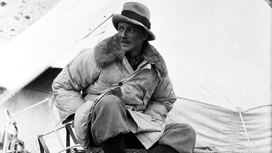 A black-and-white image of George Finch wearing the world's first puffer jacket at Everest base camp