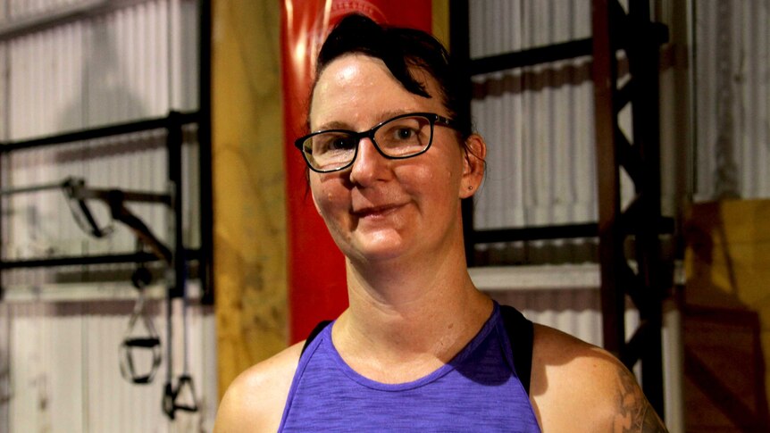 Donna Bulloch wears glasses and a purple singlet