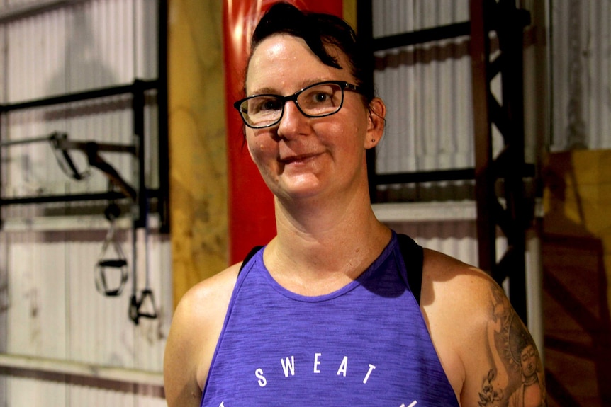 Donna Bulloch wears glasses and a purple singlet