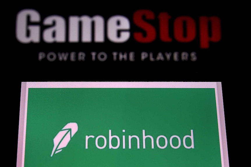 The logos of video game retail store GameStop and trading application Robinhood displayed on a computer and on a mobile phone.
