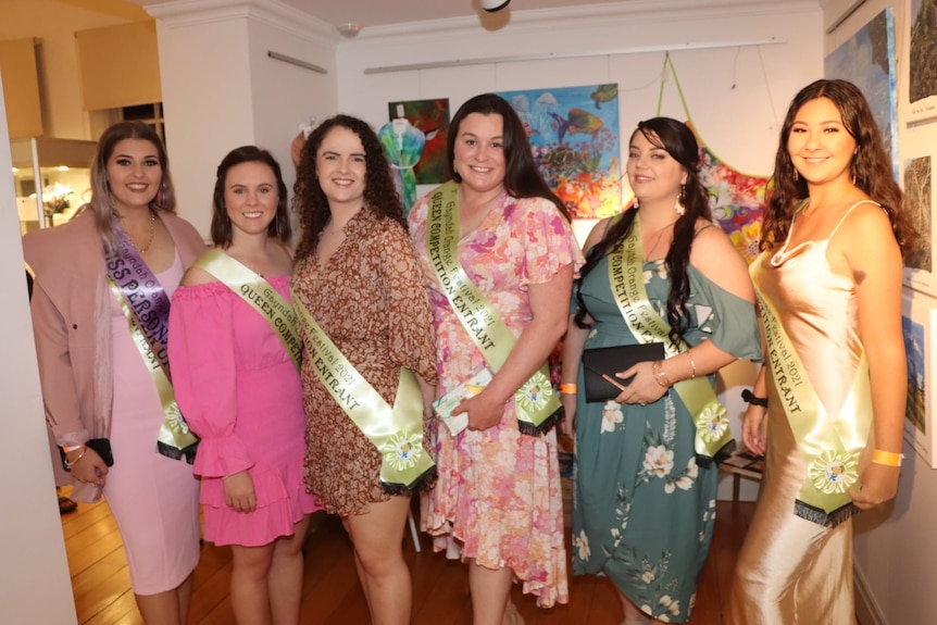 A group of women stand at a party in at gallery space.