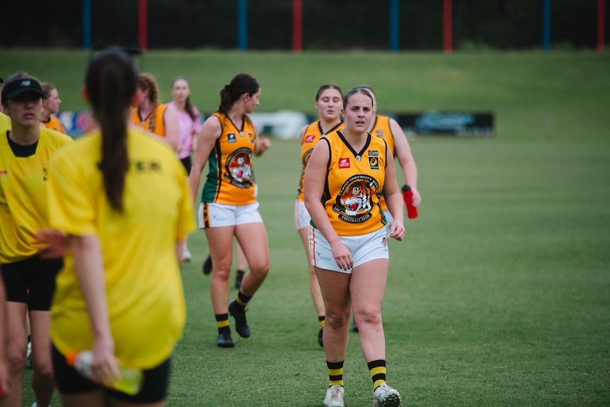 Karlee Anning walking on the field.