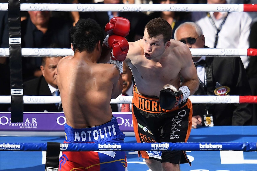 Jeff Horn (right) lands a punch on Manny Pacquiao early in the bout.