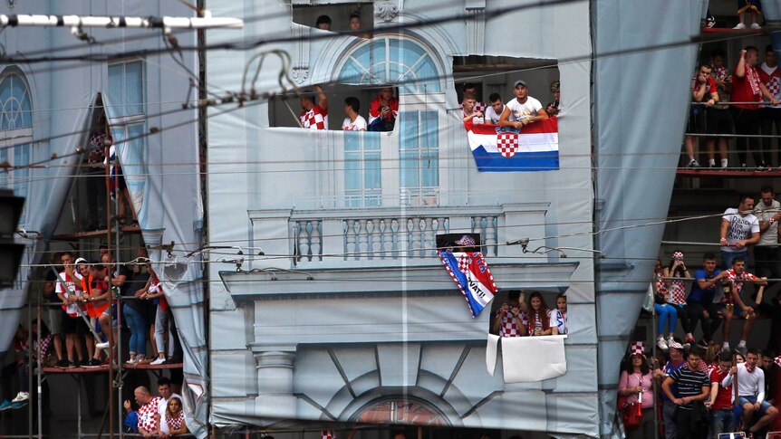 Croatia fans sit on scaffolding to watch world cup final