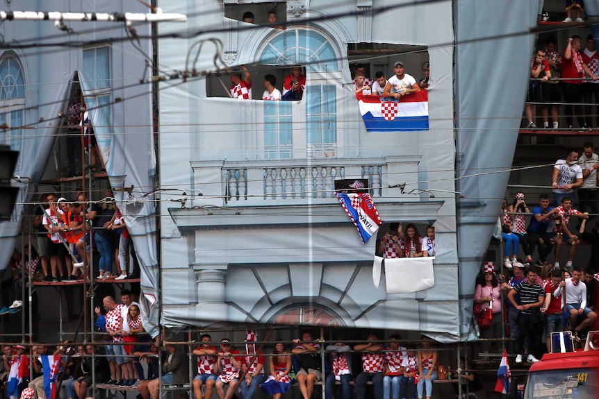 Croatia fans sit on scaffolding to watch world cup final