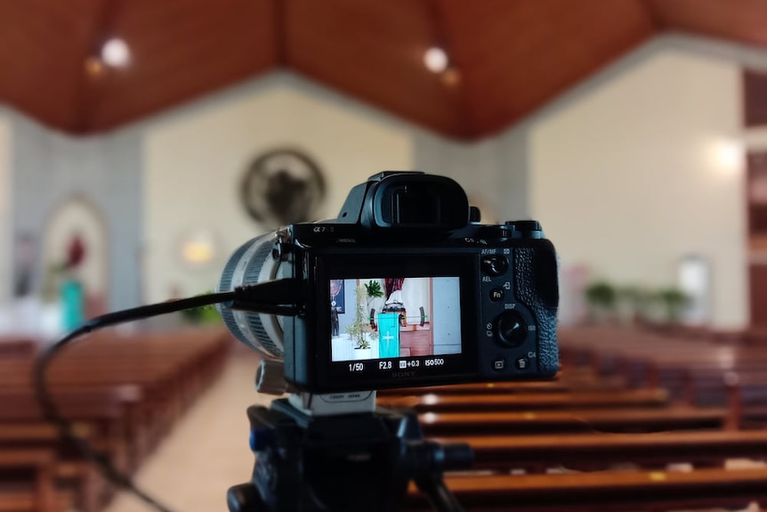 A camera inside a chapel with its screen showing the scene, ready to stream a funeral.