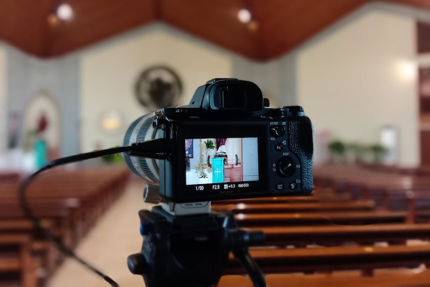 A camera inside a chapel with its screen showing the scene, ready to stream a funeral.