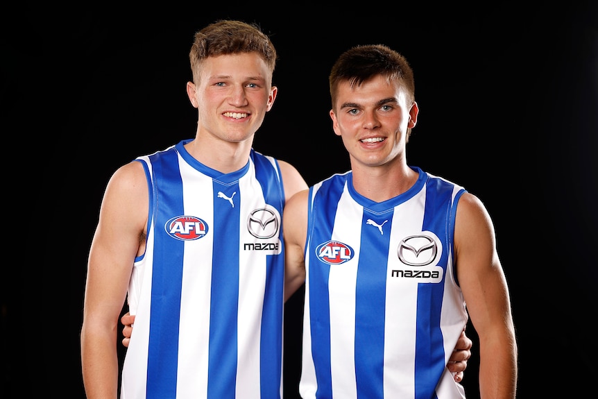 Zane Duursma and Colby McKercher stand together in North Melbourne jerseys