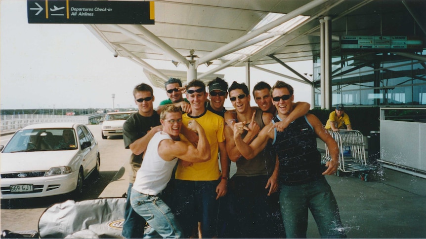 Members of the Southport Sharks AFL team pose for a photo before boarding a flight to Bali