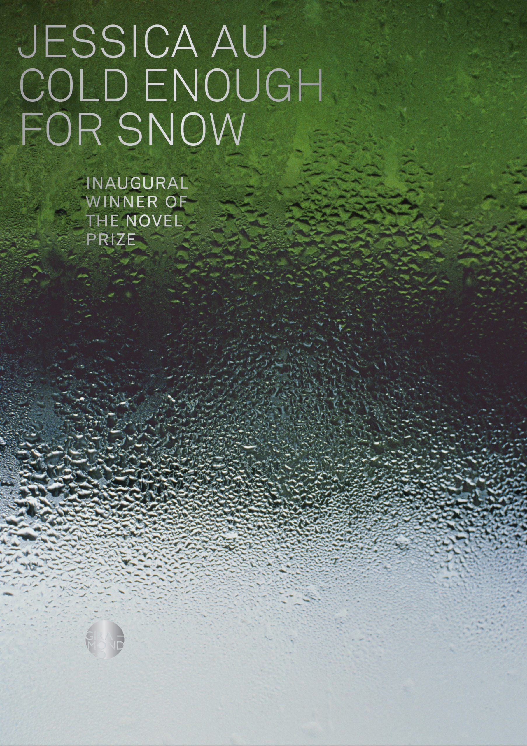 A book cover with dew condensation on the clear glass next to green.on the cover "Jessica Oh / It's Cold As It Snows"