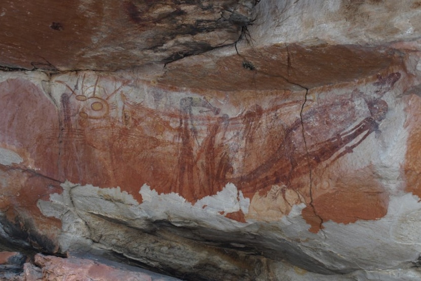Weathered rock face with red Indigenous drawings