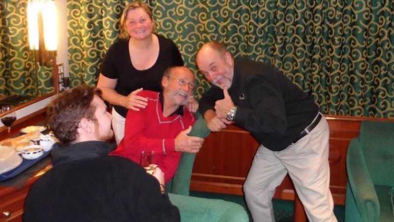 French sailor Alain Delord (red top) relaxes onboard the MV Orion following his dramatic rescue.