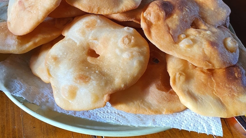 Small round fried flat breads arranged on a plate.