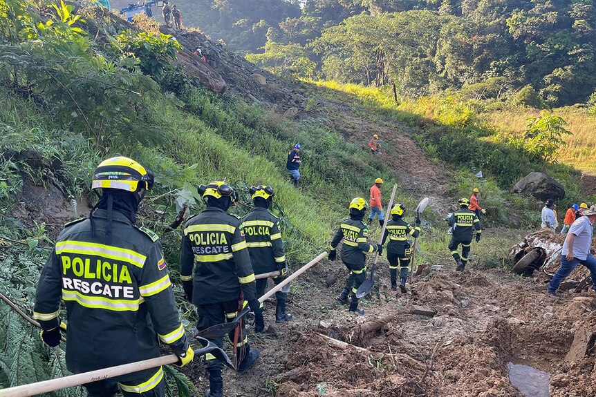 Rescuers at a landslide location in Columbia.
