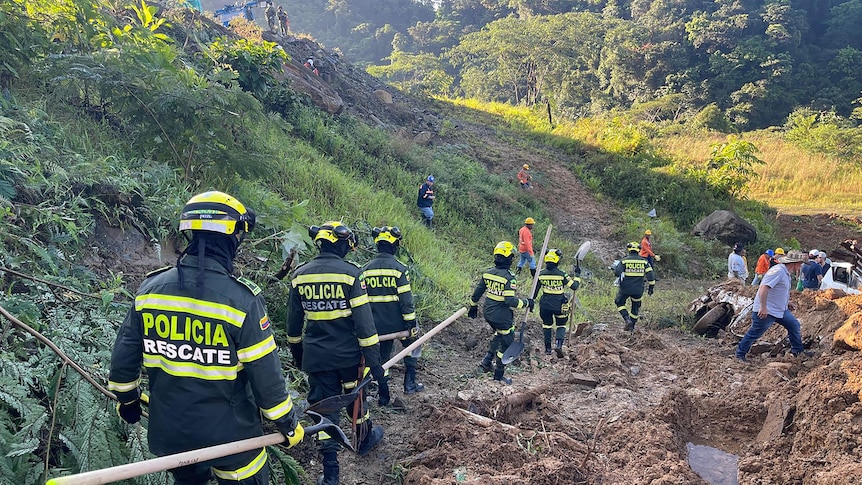 Rescuers at a landslide location in Columbia.