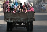 Palestinian families are evacuated after Israeli air strike in Gaza City.