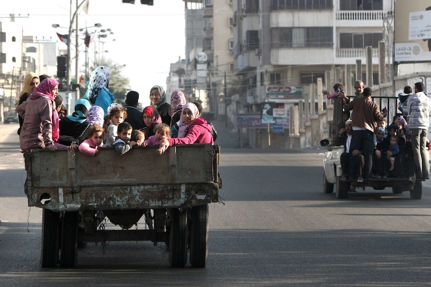 Palestinian families are evacuated after Israeli air strike in Gaza City.