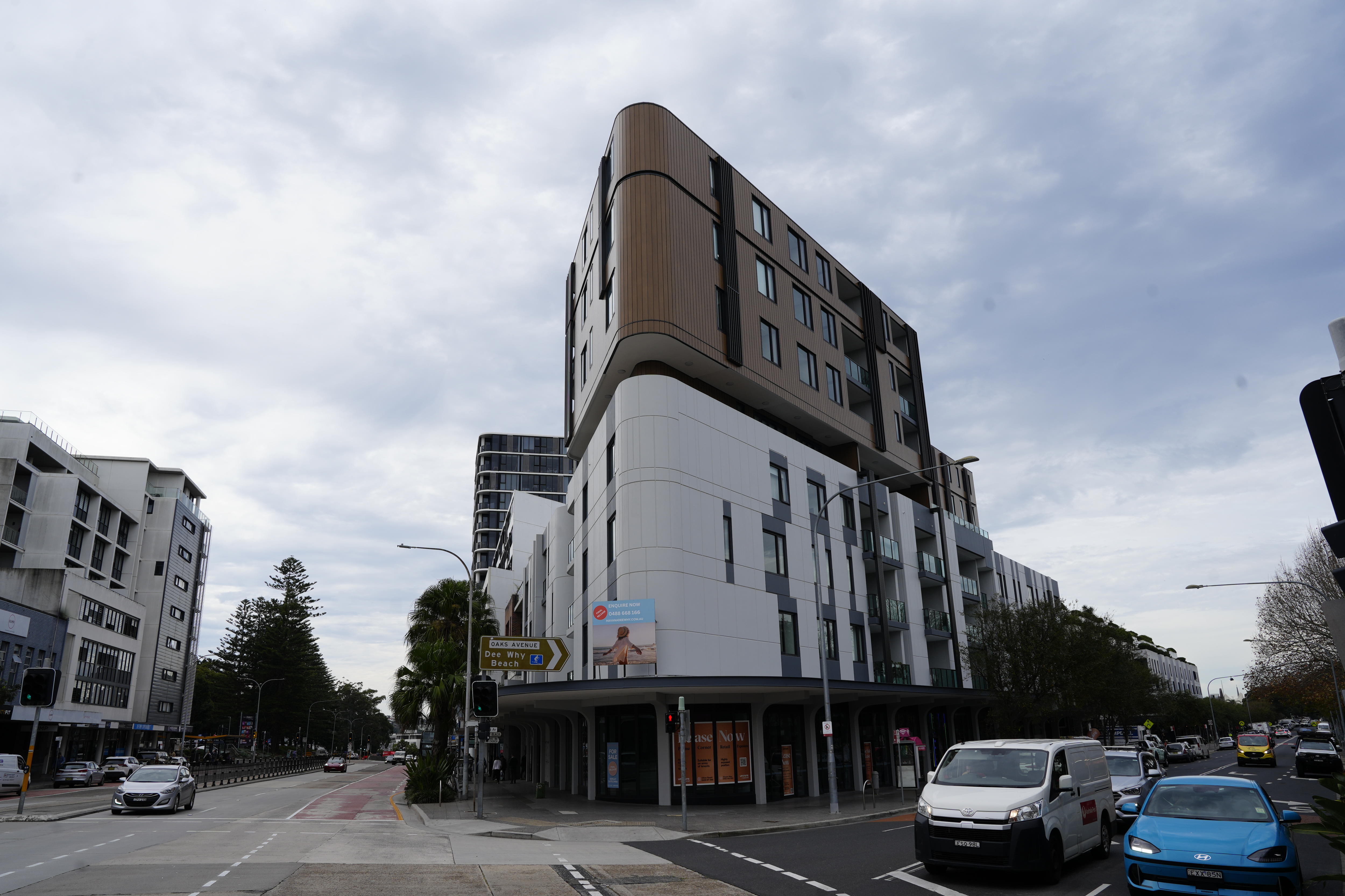 A tall apartment block sits at a busy intersection in Dee Why.