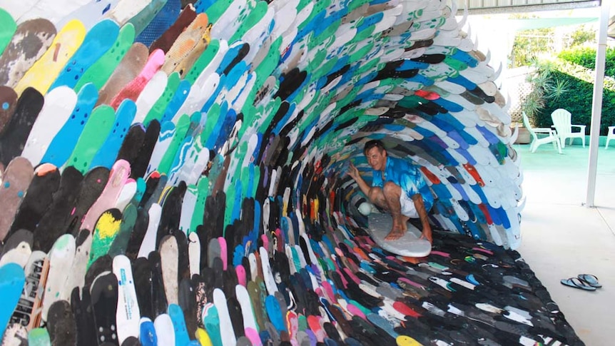 man inside a wave made out of thongs