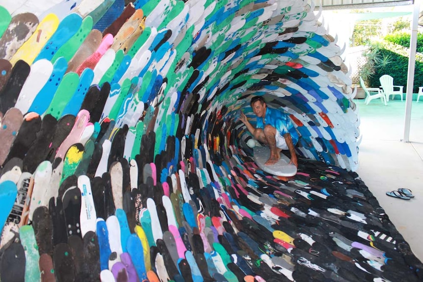 man inside a wave made out of thongs