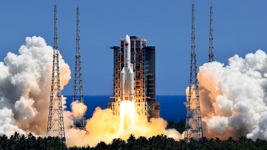 A silver rocket is launched into the sky with a trail of fire and smoke. 