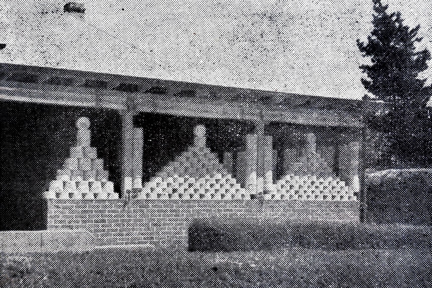 Stacks of fruit cake tins line a front verandah.