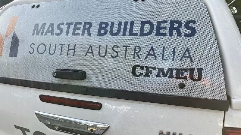 A white vehicle with Master Builders Association branding and CFMEU sticker