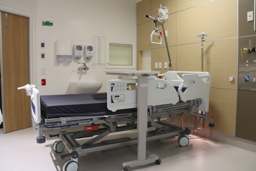 A hospital bed in a single room.