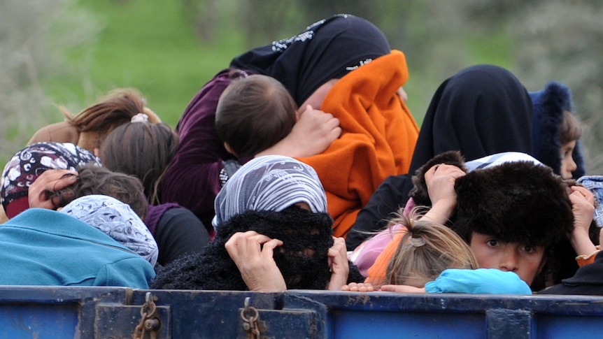 Syrians arrive near the border between Syria and Turkey at Reyhanli.