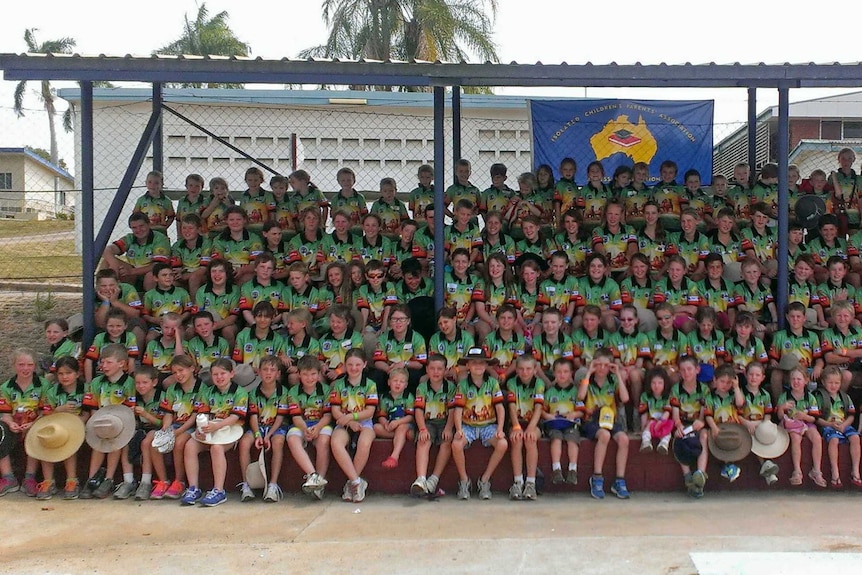 153 children wearing matching t-shirts lined up to have their photo taken at the Fit for Life camp