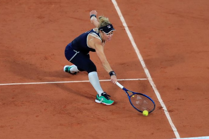 Laura Siegemund reaches for the ball but does not quite get there before it bounces on the red clay of Roland Garros.