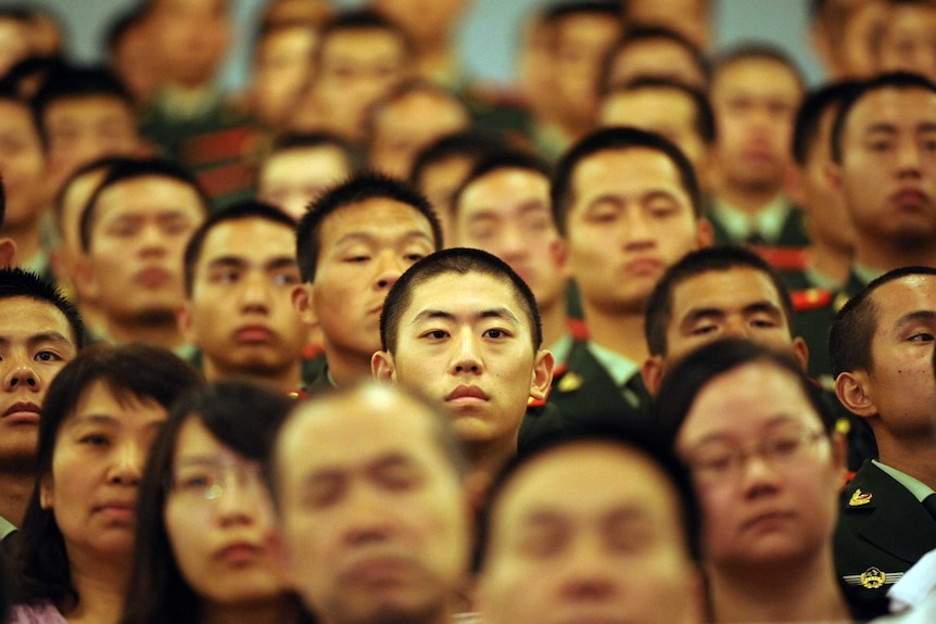 Chinese people listen to a speech from president Hu Jintao in Beijing.