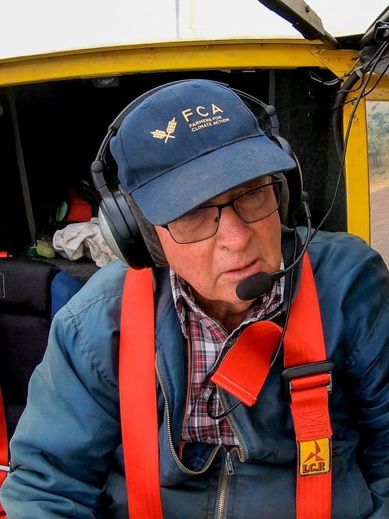 Acland farmer Sid Plant in the cockpit of his light plane flying over the New Acland Coal Mine in June 2020.