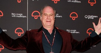 Michael Gudinski holds his hands in the air