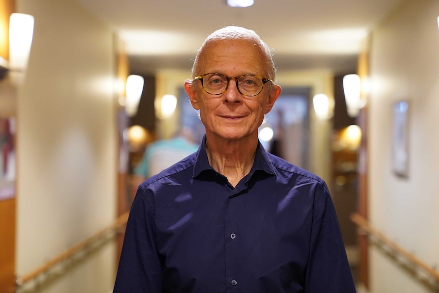 Professor Henry Brodaty stands in a hallway.