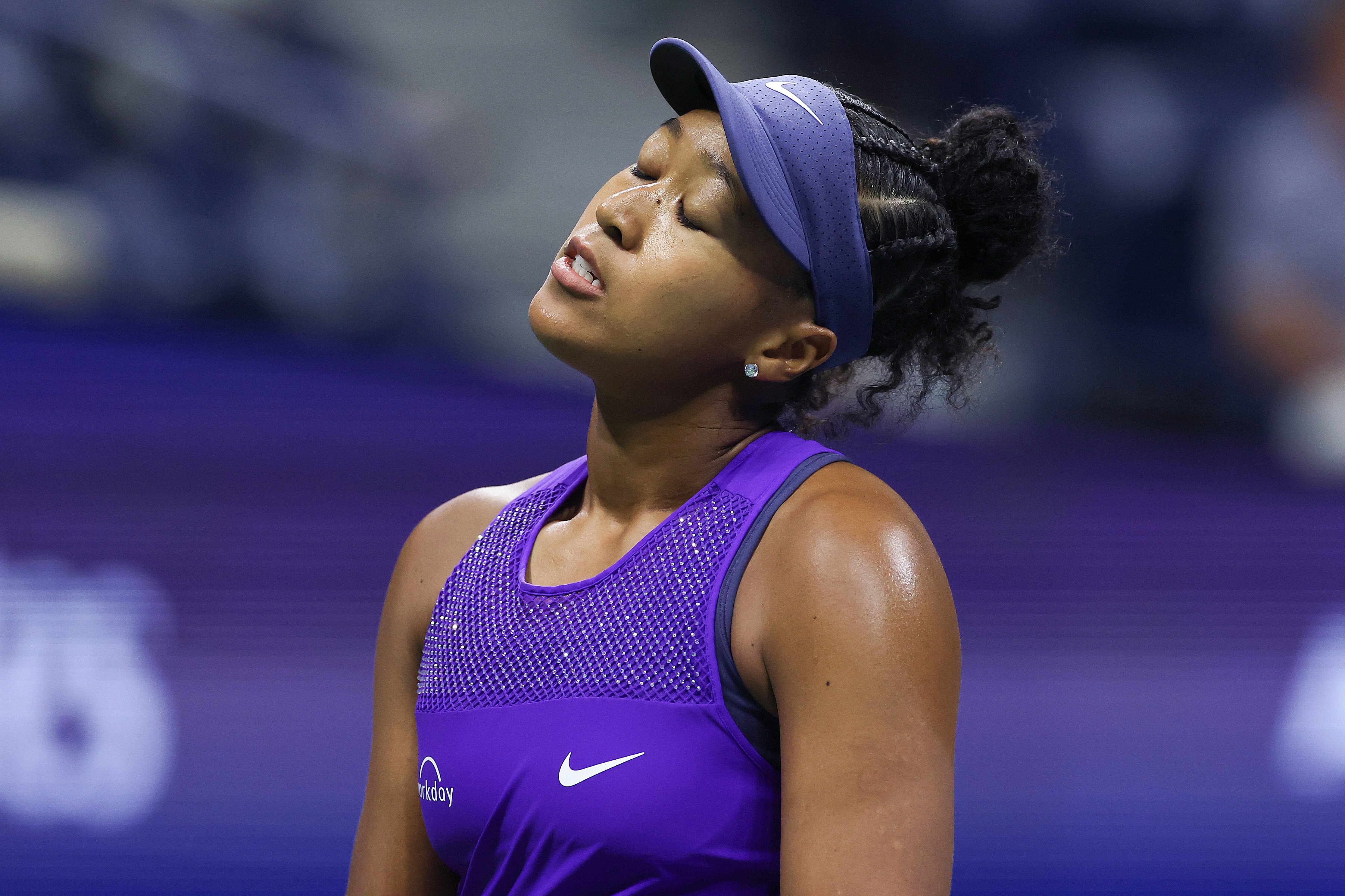 A grimace woman after losing a tennis match
