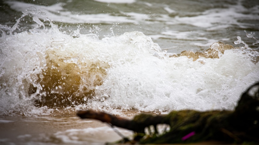 Swirling water that appears sandy brown.