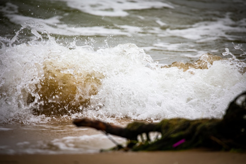 Swirling water that appears sandy brown.