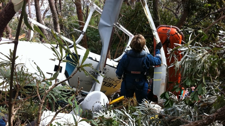 A paramedic attempts to access the wreckage of a helicopter that crashed in Central Queensland.
