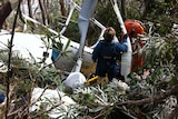 A paramedic attempts to access the wreckage of the helicopter