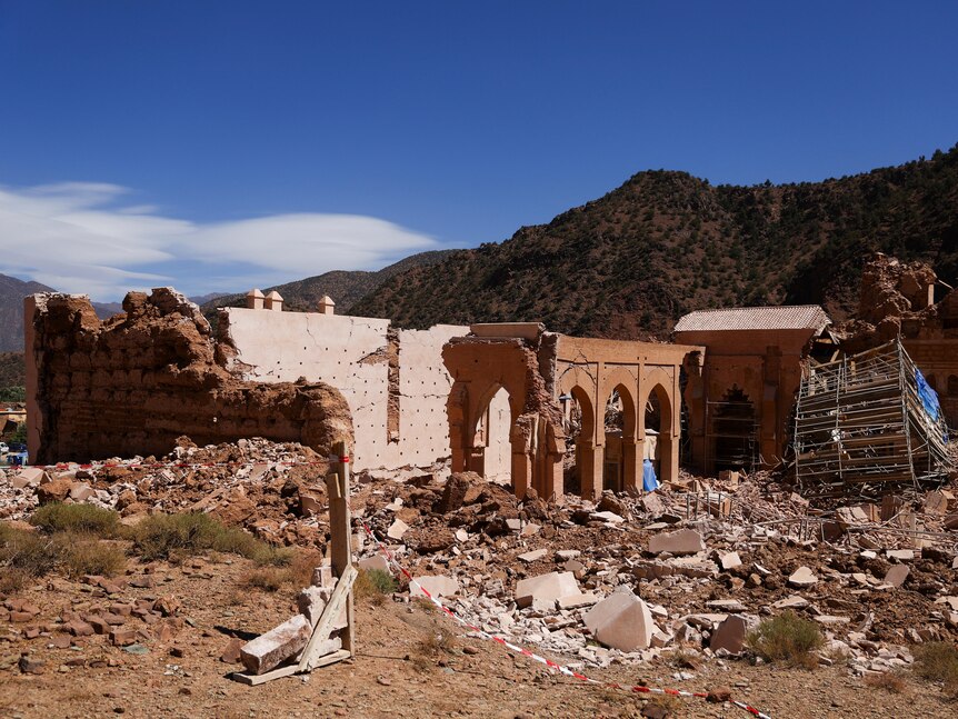 The ruins of a mosque show red brick and scaffolding all over the ground
