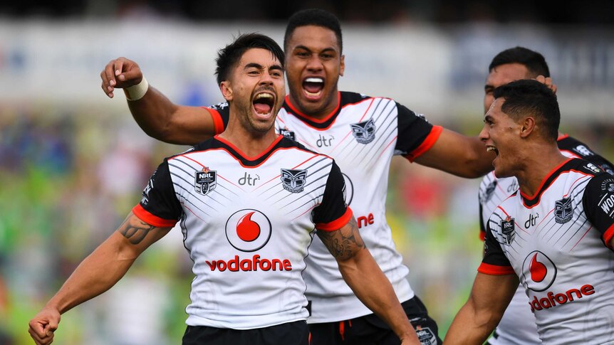 Shaun Johnson of the Warriors celebrates with team mates after winning over the Raiders in Canberra.